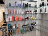 many different types of hair products displayed on the glass shelves