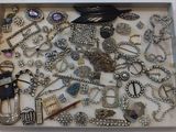 a tray with many different types of jewelry in it