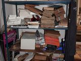 a shelf full of boxes and other items in a room