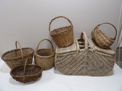 several wicker baskets are lined up on a white table