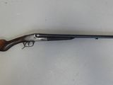 un fusil de chasse posé sur une table près d'un mur