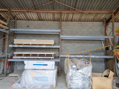 a room that has a lot of shelves and pallets in it