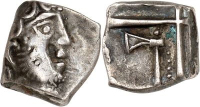 a close up of a coin with a cross on it