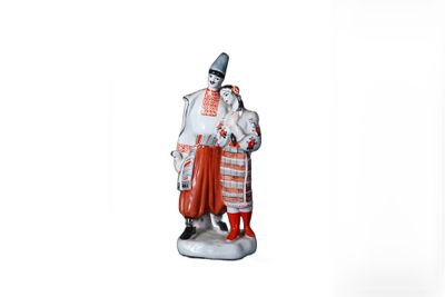 figurine of a man and a woman dressed in traditional clothing