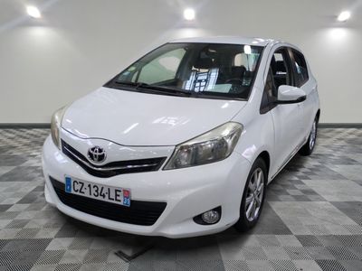 a picture of a white toyota yaris parked in a garage
