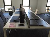 an image of an empty office with computers and desks