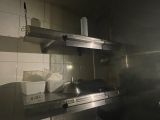 a kitchen with a stove top and a sink