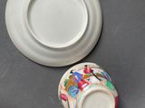 a small cup and saucer sitting on a table
