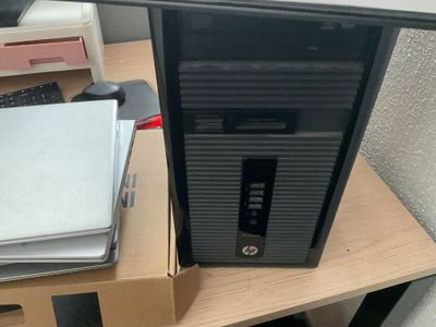 un ordinateur de bureau posé sur un pupitre en bois