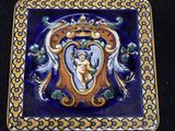 a blue and yellow tile with a picture of a woman on it
