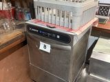 a silver dishwasher sitting on top of a cart in a kitchen