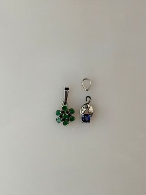 pair of green and blue crystal earrings on a white surface