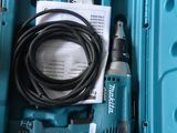 a blue box with a drill and a cord in it