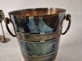 a silver cup with handles on a white background