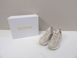 guess shoes in a box and a pair of shoes on a table