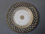a white plate with a gold rim and a pattern on it