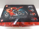 a box with a lego motorcycle in it on a table