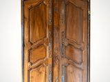 an image of a wooden armoire with carvings on the doors