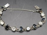 silver bracelet with black and clear glass beads on a silver chain