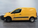 the yellow van is parked on the concrete floor in the room