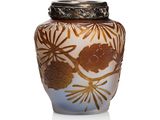 a vase that has a gold and white design on it