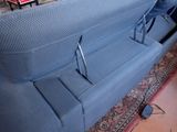 a blue couch that is sitting in a room