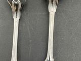 two spoons and a fork are sitting on a table