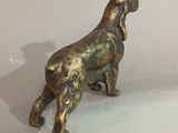bronze figurine of a dog standing on its hind legs