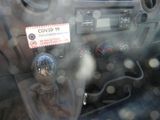a sticker on the dashboard of a car that reads covidd 19