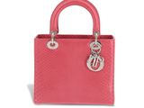 a pink handbag with a metal handle on a white background