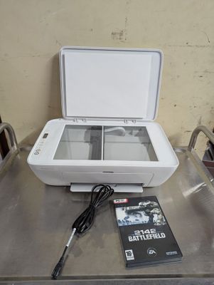 a printer that is sitting on a table with a dvd
