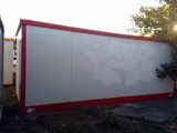 a white and red container sitting in a yard