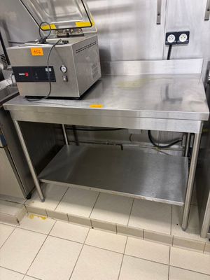 a kitchen with a stainless steel table and a stove