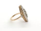 a close up of a gold and diamond ring on a white background