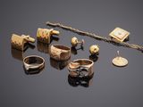 an assortment of rings, bracelets, and rings on a black surface