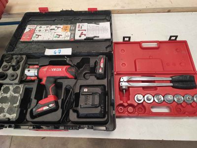 a red tool case with tools in it on a table