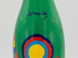 green bottle with red and blue design on it