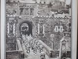 an old black and white photo of a castle with a crowd of people