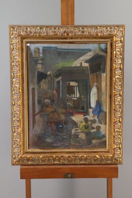 painting on easel of a street scene with a man and a woman in the background