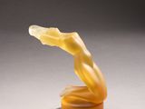 a close up of a sculpture of a woman ' s torso on top of a table