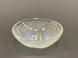 a clear glass bowl with a decorative design on it