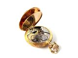 a gold pocket watch with a chain attached to it