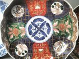 three decorative plates with decorative designs on them sitting on a table