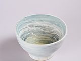a white and blue bowl sitting on a table