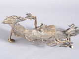 a metal sculpture of a bird on a branch