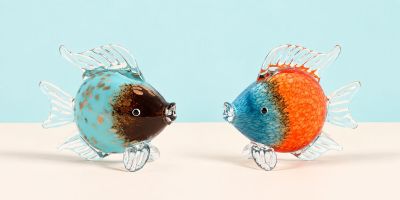 two fish figurines that are sitting on a table