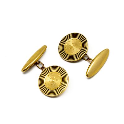 two pairs of gold cufflinks on a white background