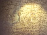 a shadow of a man on a map of the world