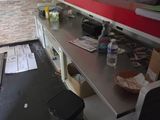 an image of a kitchen with a counter and a trash can