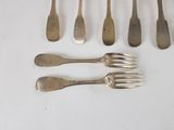 six forks and five spoons are arranged on a white surface